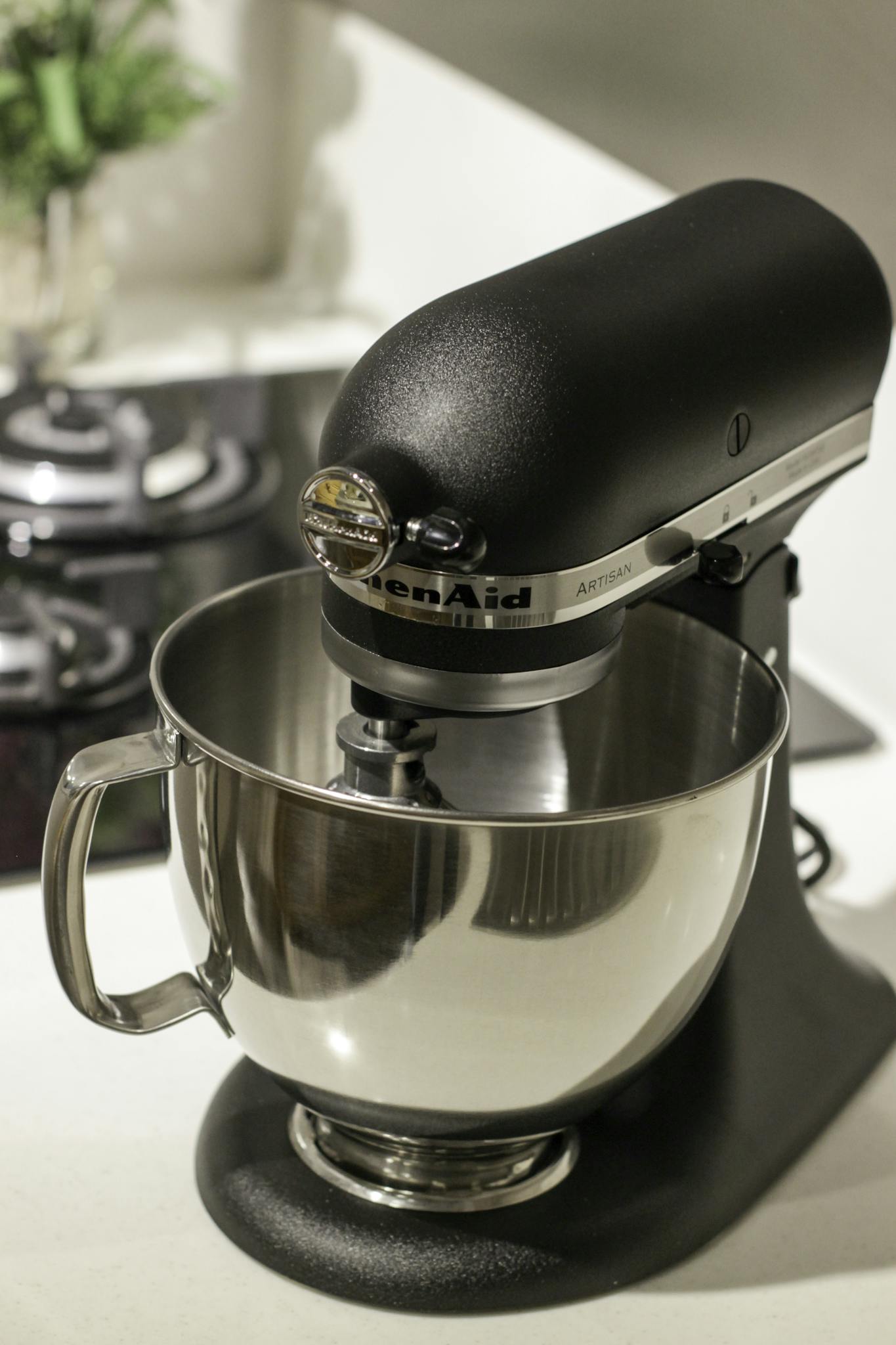 A stylish black kitchen mixer in a modern kitchen setting, perfect for baking needs.